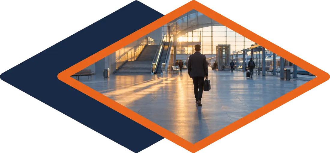 Walking through a station concourse, framed by the 22Academy diamond